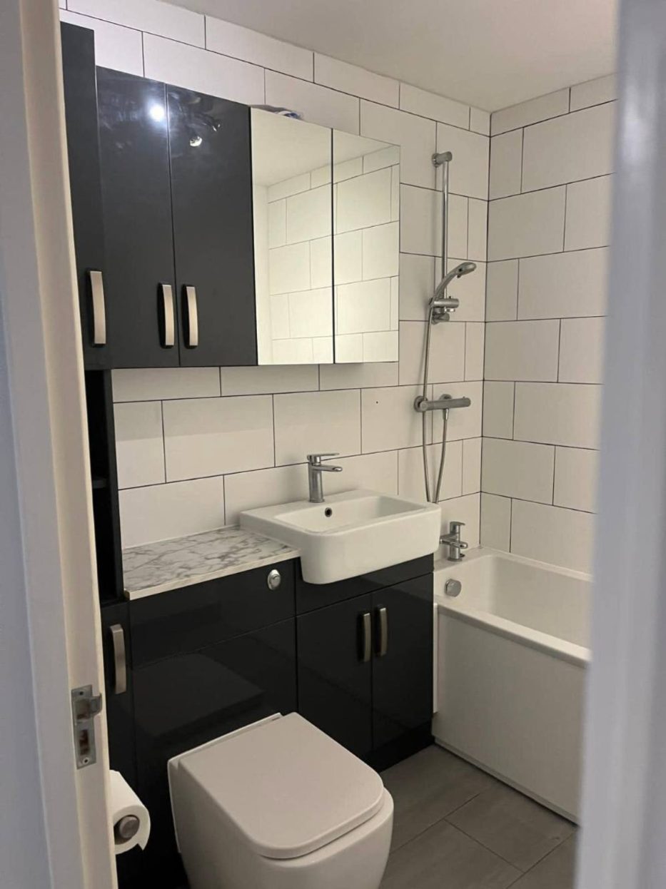 Bathroom with dark gloss vanity units