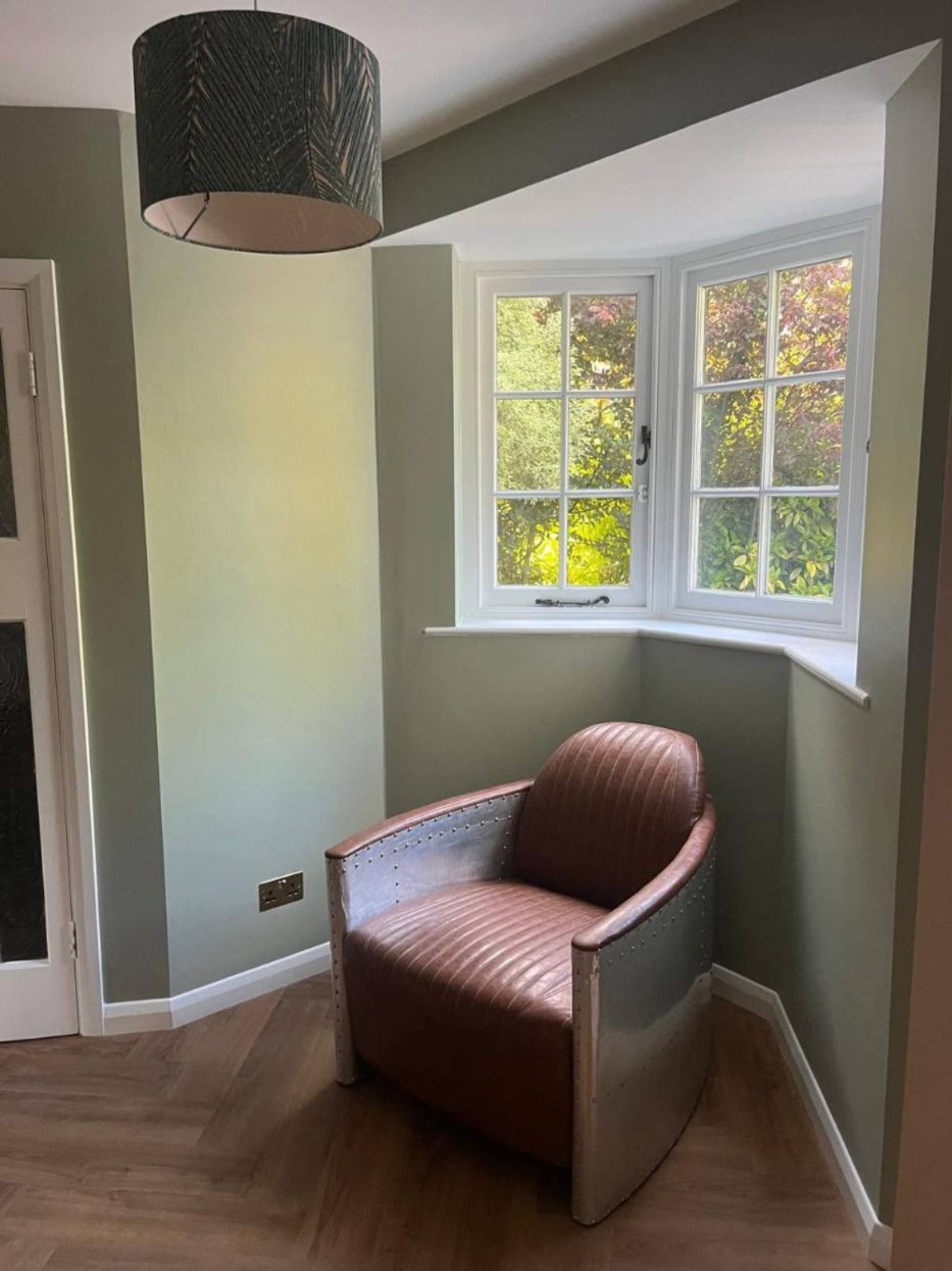 Finished room with bay window and herringbone floor