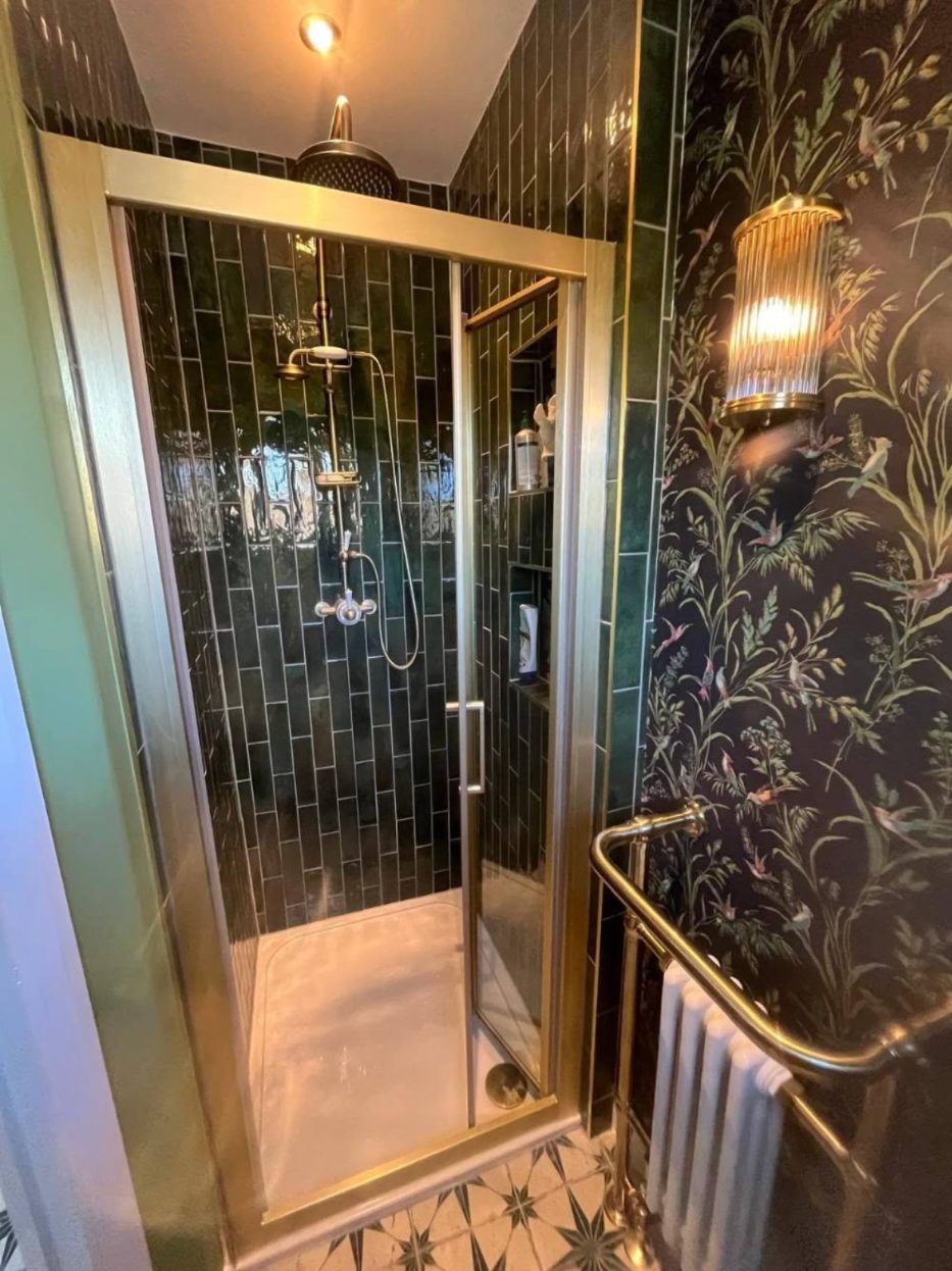 Shower room with green tiles and brass fittings