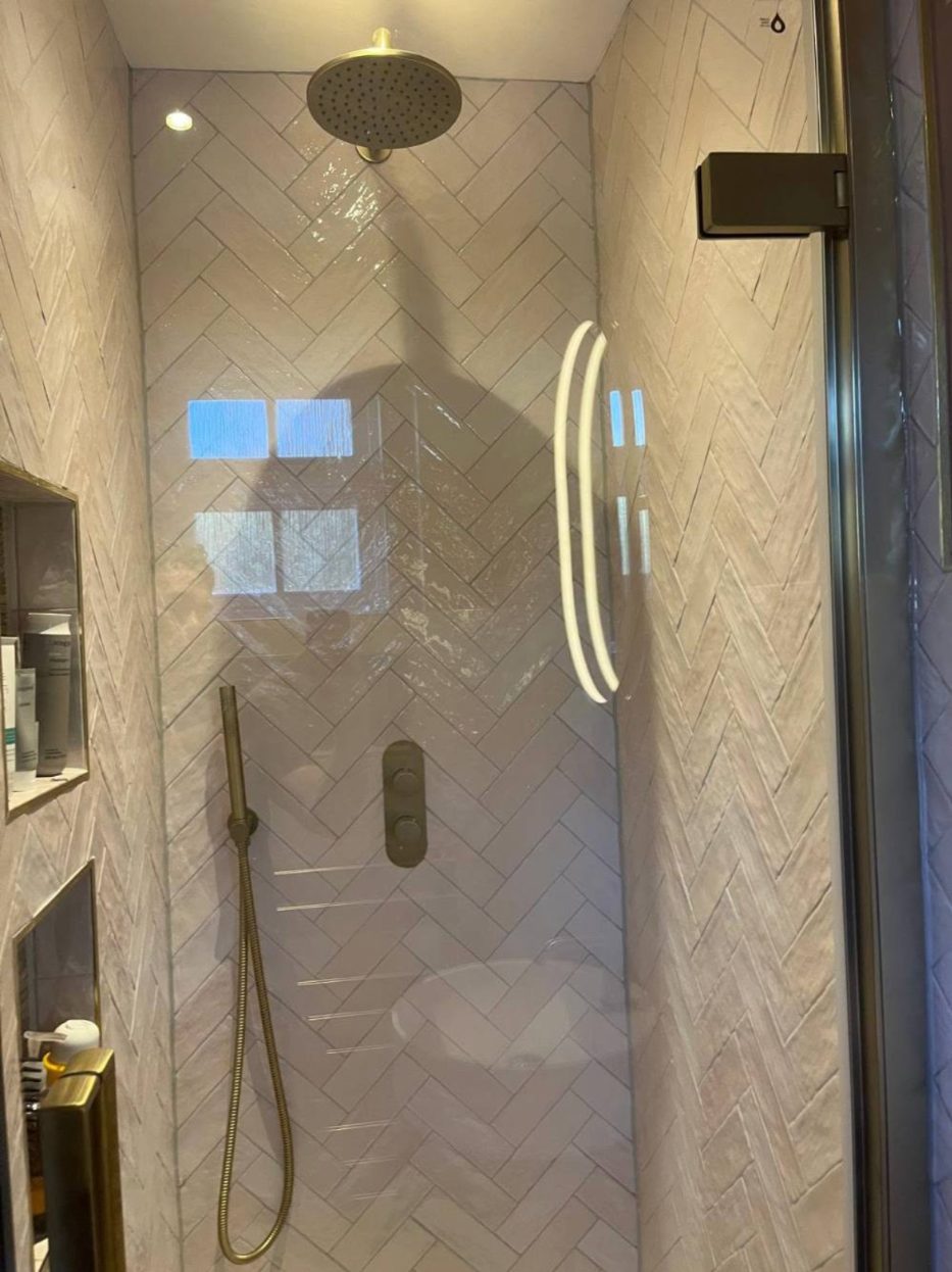 Walk-in shower with herringbone tiles